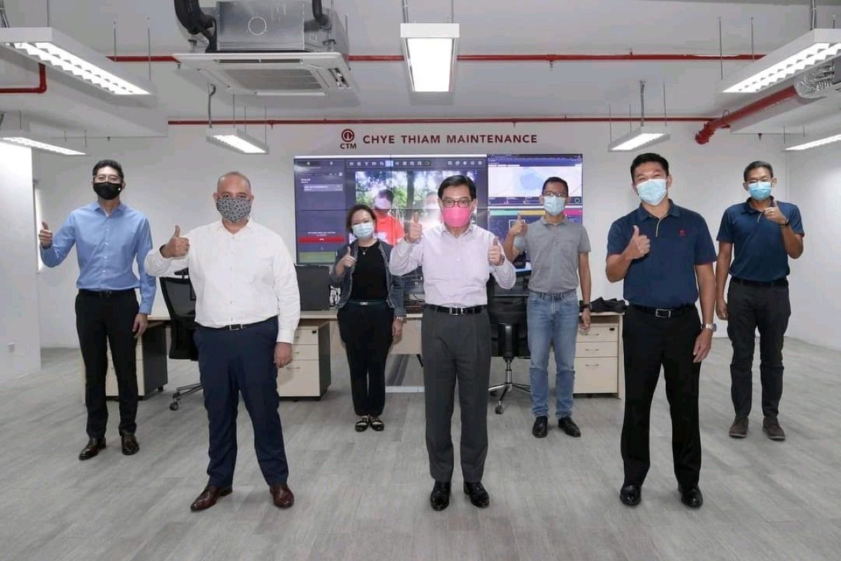 The visiting party and the Chye Thiam Maintenance team standing together in the operations room after the demonstration.