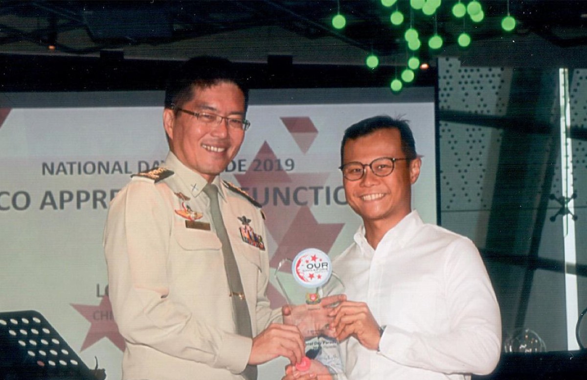 Terence Kok receiving the NDP Silver Award 2019 at the National Day Parade appreciation function.