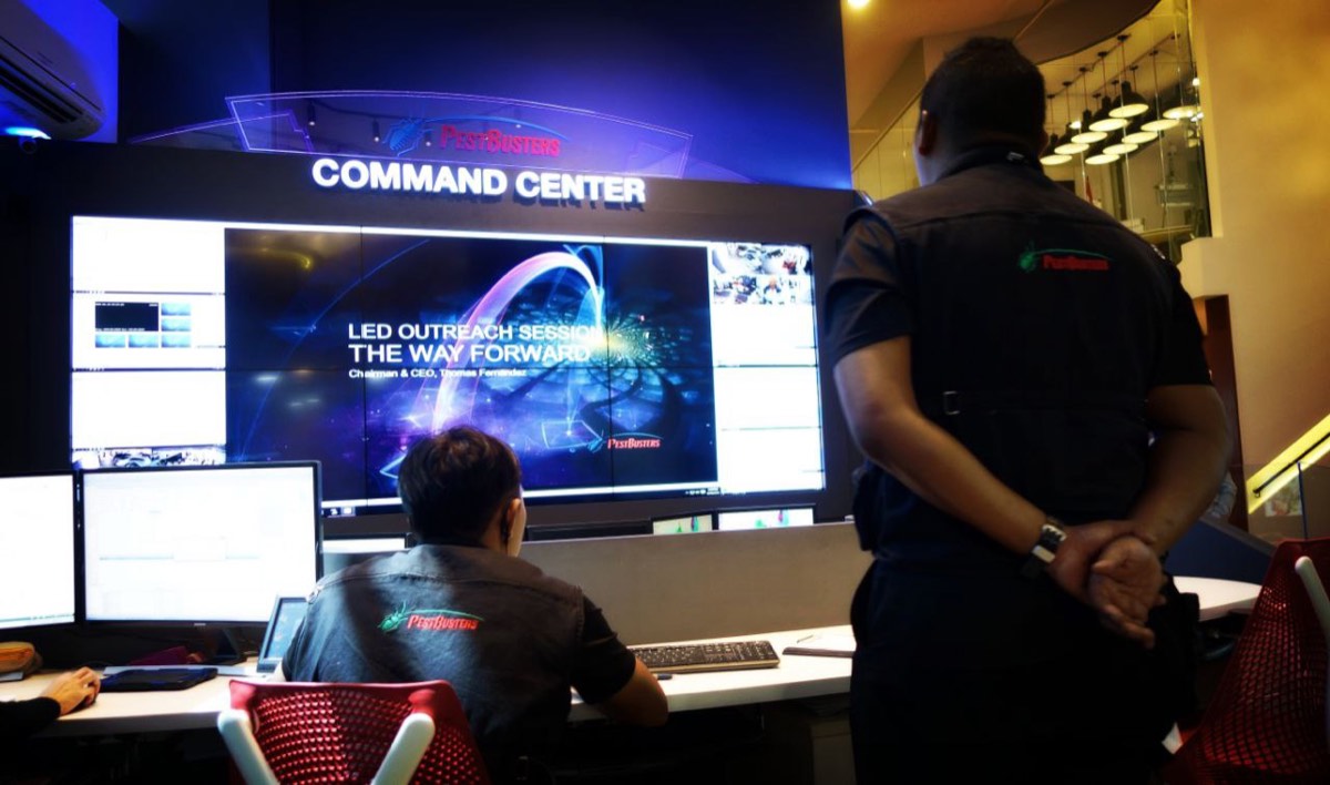 The PestBusters command centre during the review, an operator at the console in front of the video wall.