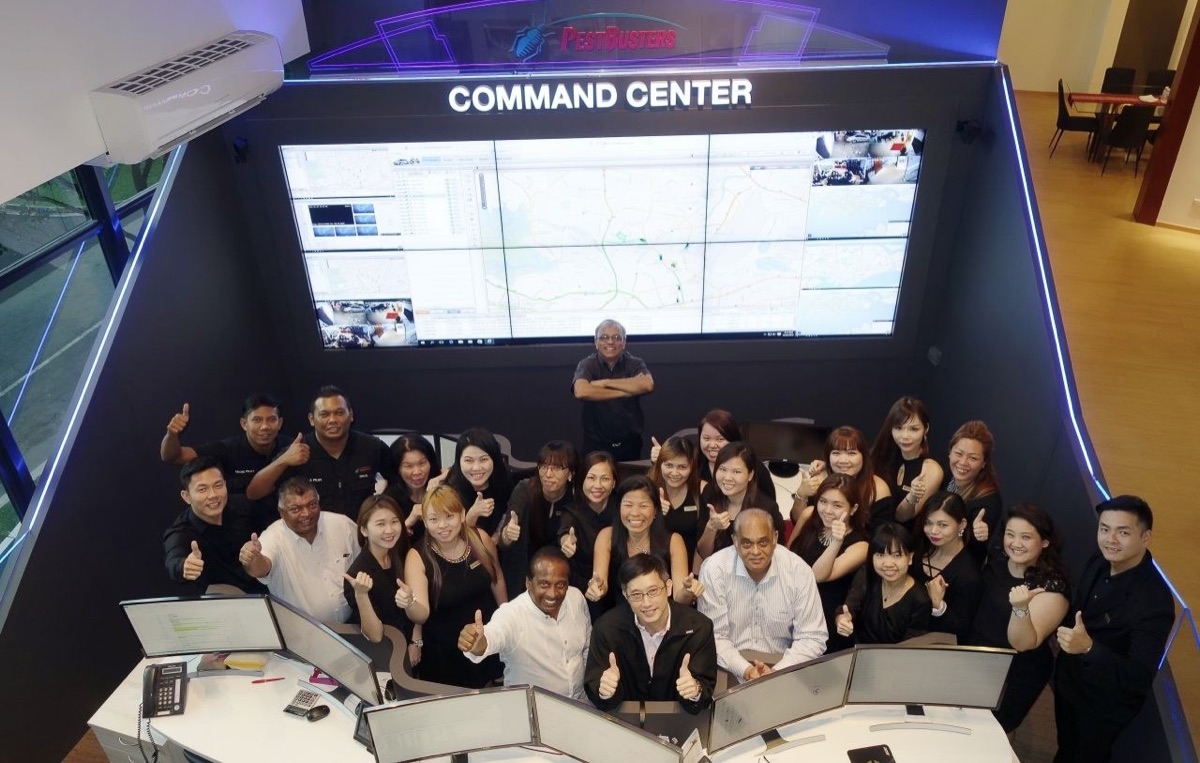 The PestBusters and Orion Five team together at the command centre after training, all giving a thumbs up.