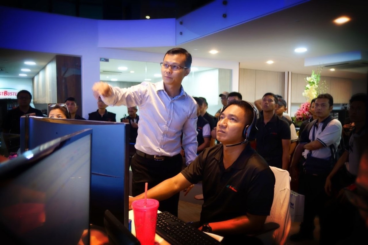Terence Kok training a PestBusters technician at the command centre console.
