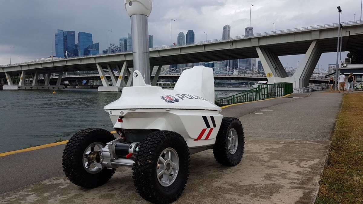 The four-wheeled S5 patrol robot in police livery, photographed outdoors by the waterfront.